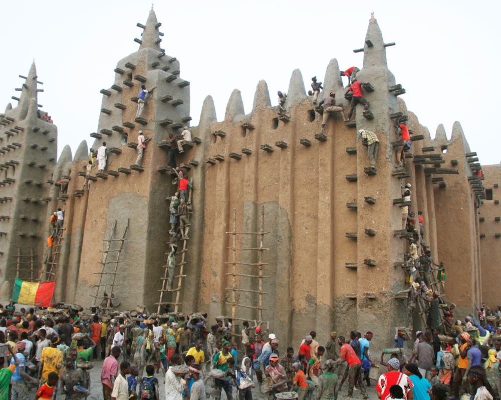 Community members re-mudding the Great Mosque of Djenné.